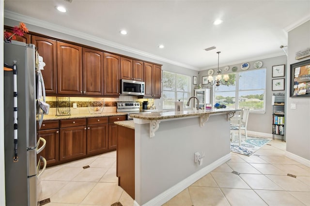 kitchen with an island with sink, decorative light fixtures, backsplash, stainless steel appliances, and a breakfast bar