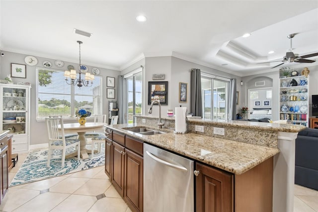 kitchen with sink, ceiling fan with notable chandelier, hanging light fixtures, a fireplace, and stainless steel dishwasher