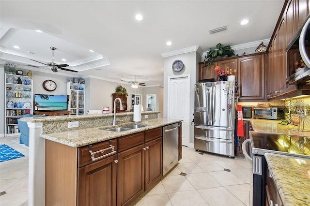 kitchen with ceiling fan, ornamental molding, stainless steel appliances, and sink