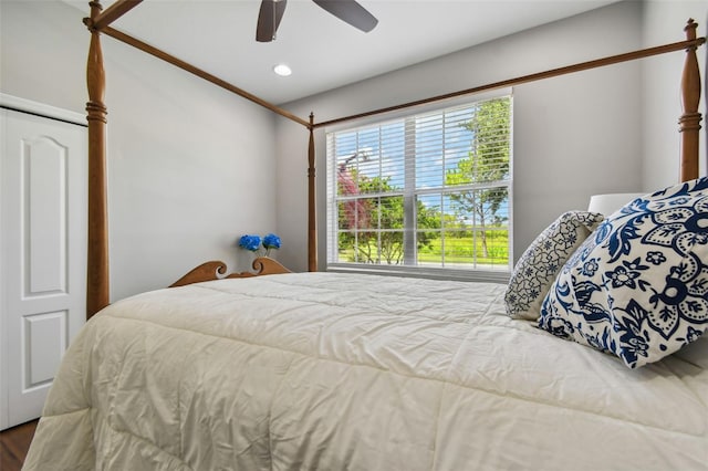 bedroom featuring wood-type flooring, ceiling fan, and a closet