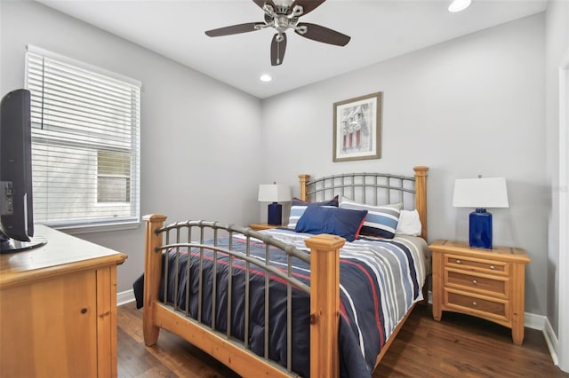 bedroom featuring ceiling fan, dark hardwood / wood-style floors, and multiple windows