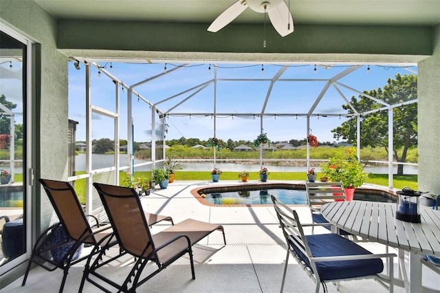 view of patio / terrace with ceiling fan, a water view, and a lanai