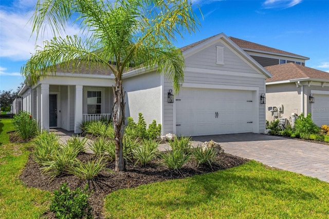 view of front of house with a porch, a garage, and a front yard