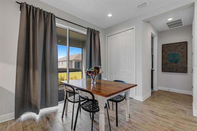 dining space featuring light wood-type flooring