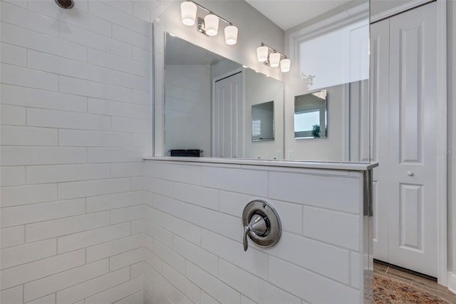 bathroom with hardwood / wood-style floors and walk in shower