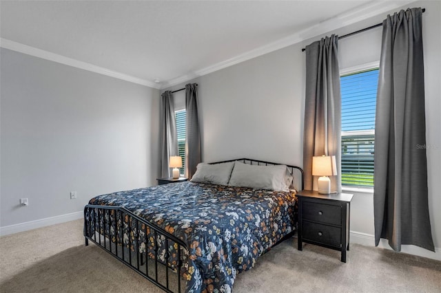 carpeted bedroom featuring baseboards and crown molding