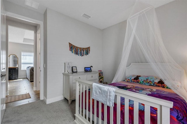 bedroom with light carpet, baseboards, and visible vents