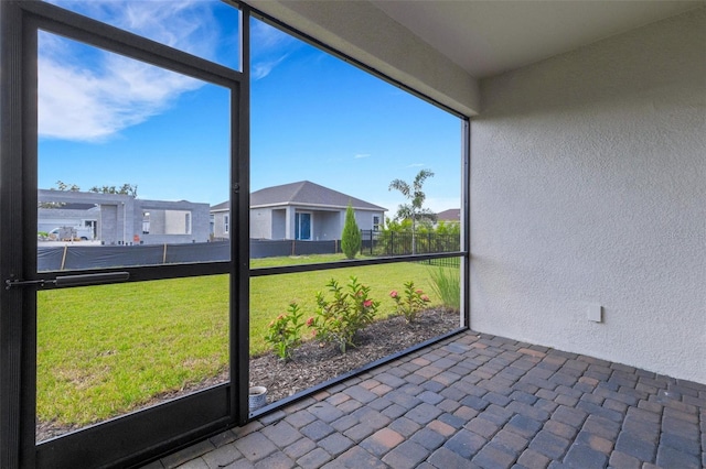 unfurnished sunroom with a residential view