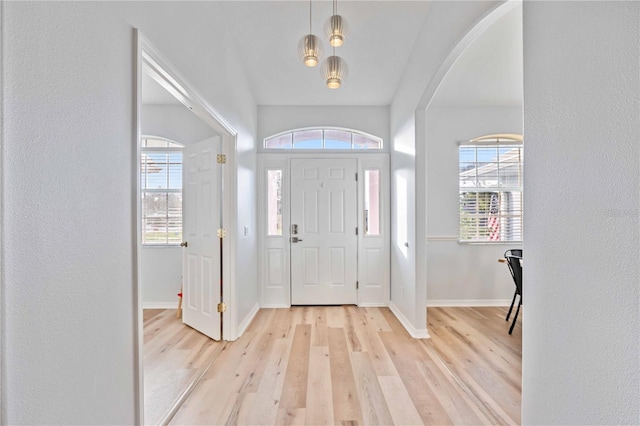 entrance foyer with light hardwood / wood-style floors and a healthy amount of sunlight