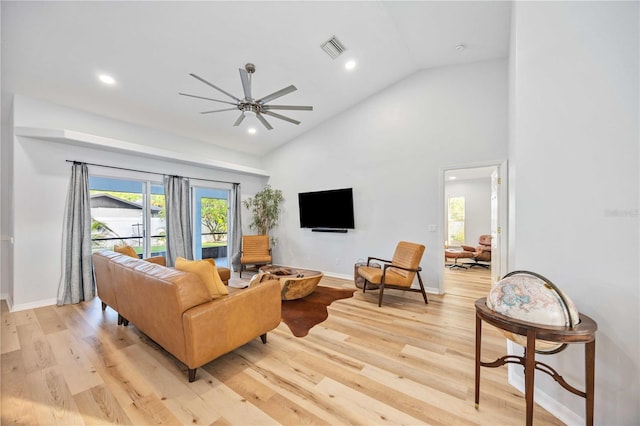 living room with high vaulted ceiling, light hardwood / wood-style floors, and ceiling fan