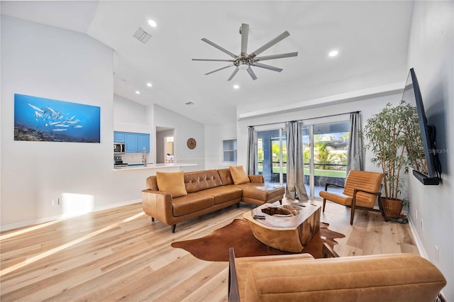 living room featuring light wood-type flooring, ceiling fan, and high vaulted ceiling