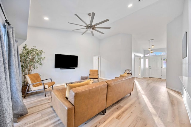 living room with light hardwood / wood-style floors and ceiling fan