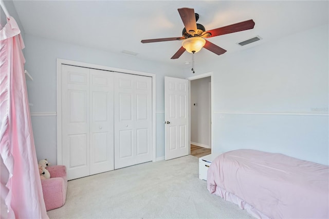 carpeted bedroom with a closet and ceiling fan