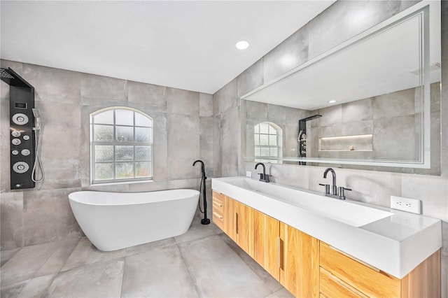 bathroom featuring tile walls, tile patterned flooring, vanity, and separate shower and tub