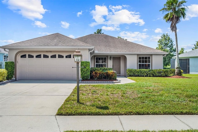 ranch-style home featuring a garage and a front yard