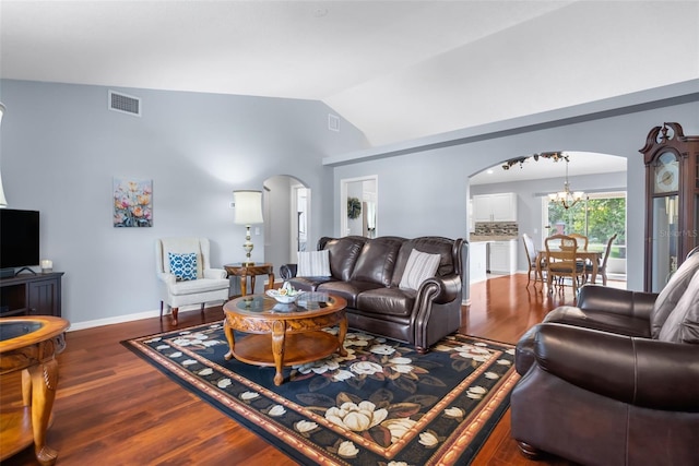 living room with an inviting chandelier, dark hardwood / wood-style flooring, and high vaulted ceiling