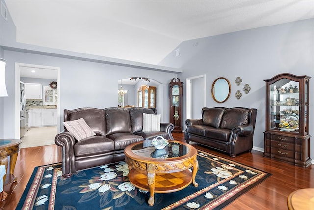 living room featuring vaulted ceiling and hardwood / wood-style flooring