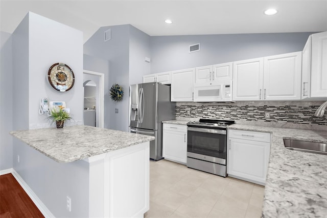 kitchen with kitchen peninsula, white cabinetry, sink, and stainless steel appliances