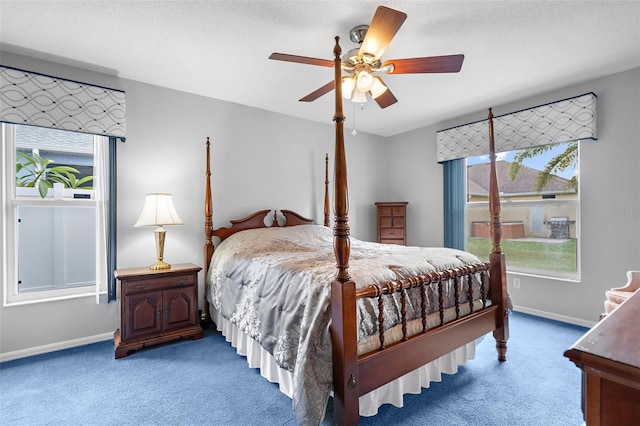 bedroom with ceiling fan and dark colored carpet