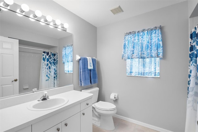 bathroom with vanity, tile patterned flooring, and toilet