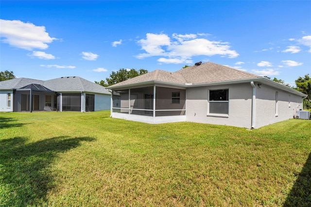 back of house with a sunroom, cooling unit, and a yard