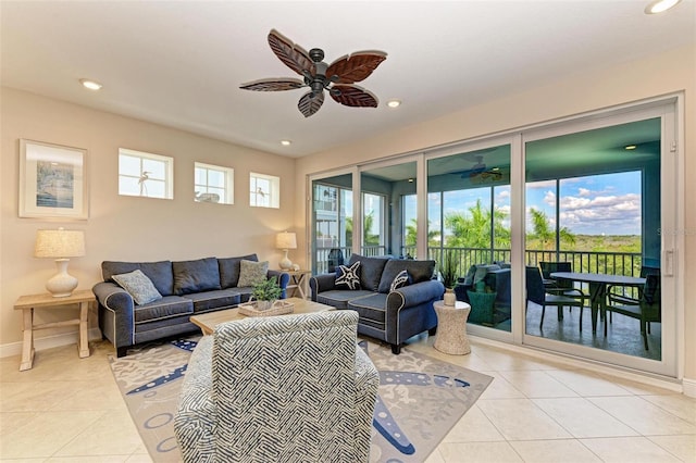 living room with ceiling fan, plenty of natural light, and light tile patterned flooring