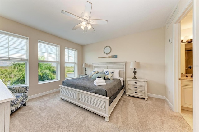 carpeted bedroom featuring ceiling fan and ensuite bathroom