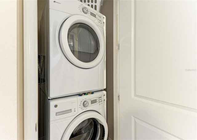 washroom featuring stacked washer / drying machine