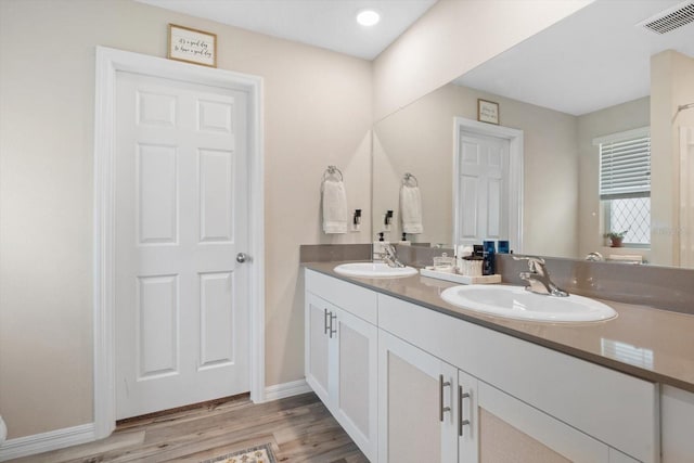 bathroom with vanity and wood-type flooring