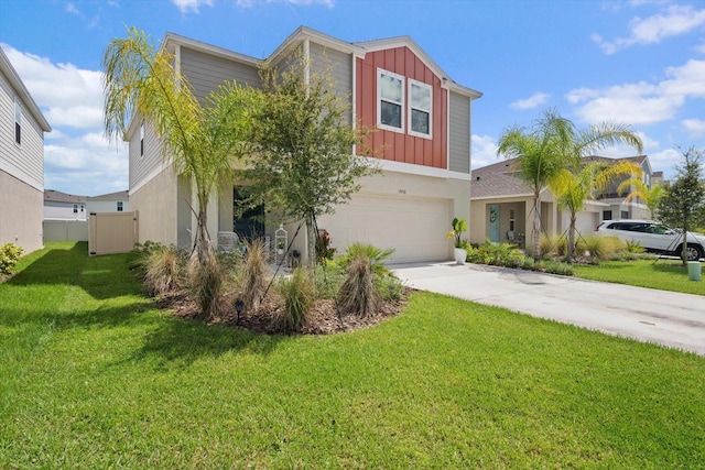 view of front of home with a front yard and a garage