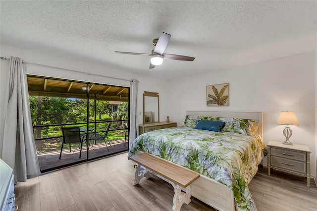 bedroom with light hardwood / wood-style floors, ceiling fan, access to exterior, and a textured ceiling