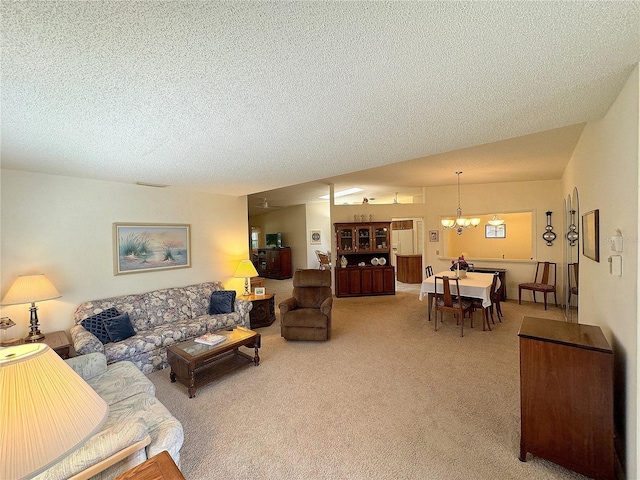 carpeted living room with an inviting chandelier and a textured ceiling