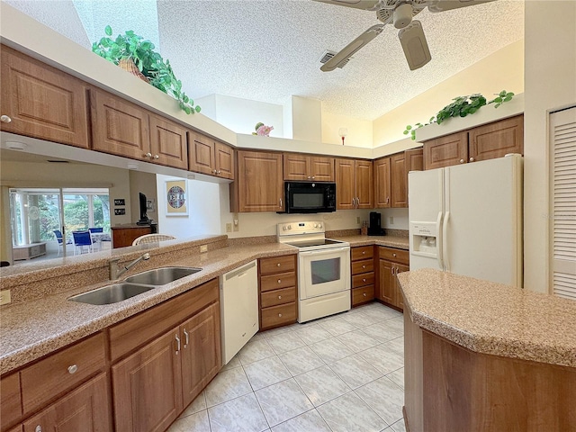 kitchen with a textured ceiling, kitchen peninsula, sink, and white appliances