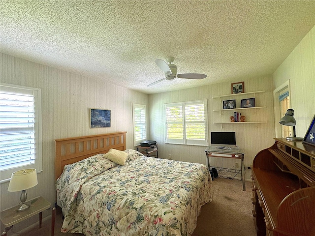 bedroom featuring a textured ceiling, carpet, and ceiling fan