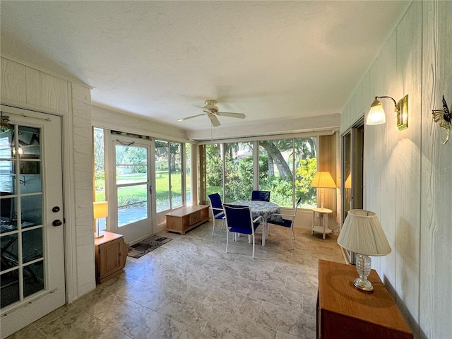 sunroom featuring ceiling fan