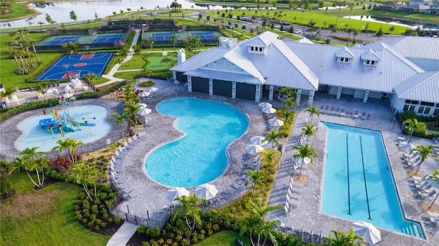 view of swimming pool featuring a water view