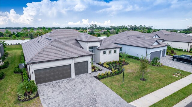 view of front of property with a front yard and a garage