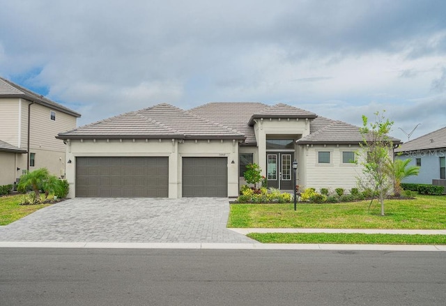 view of front facade with a garage and a front lawn