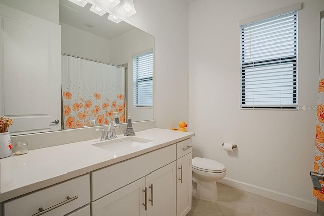 bathroom with tile patterned flooring, vanity, toilet, and walk in shower