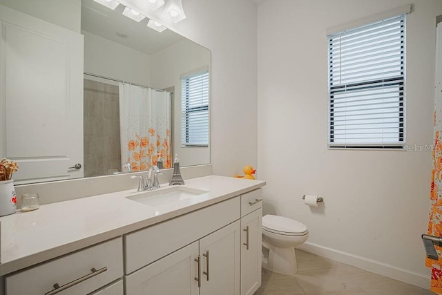 bathroom featuring toilet, vanity, tile patterned floors, and plenty of natural light