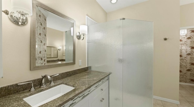 bathroom with tile patterned floors, vanity, and walk in shower