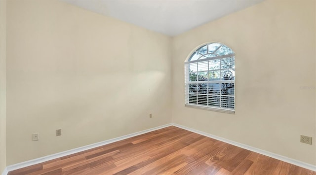 unfurnished room with hardwood / wood-style floors