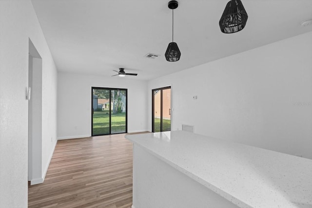 empty room with ceiling fan and light wood-type flooring