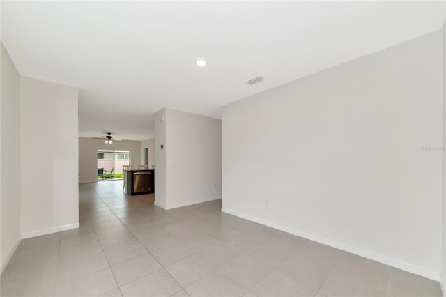 spare room with light tile patterned floors and ceiling fan