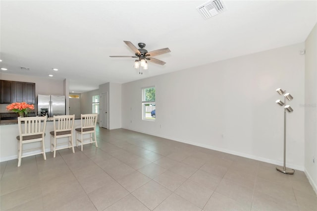 living room featuring ceiling fan and light tile patterned floors