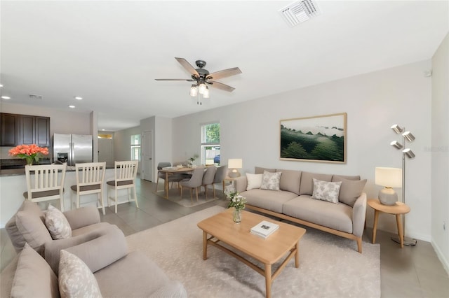 tiled living room featuring ceiling fan