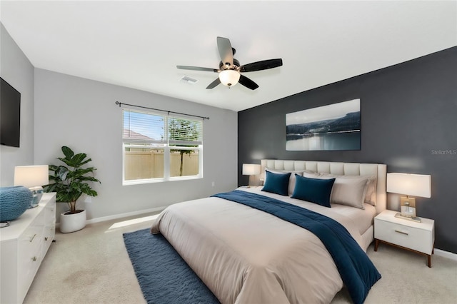 bedroom with ceiling fan and light colored carpet