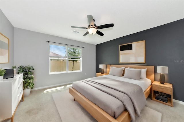 bedroom with ceiling fan and light colored carpet