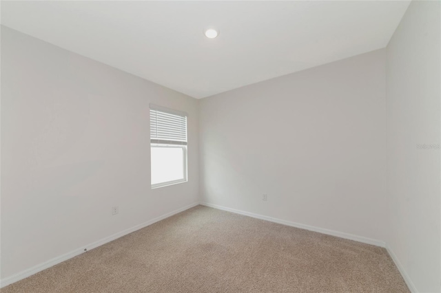 unfurnished room featuring light colored carpet