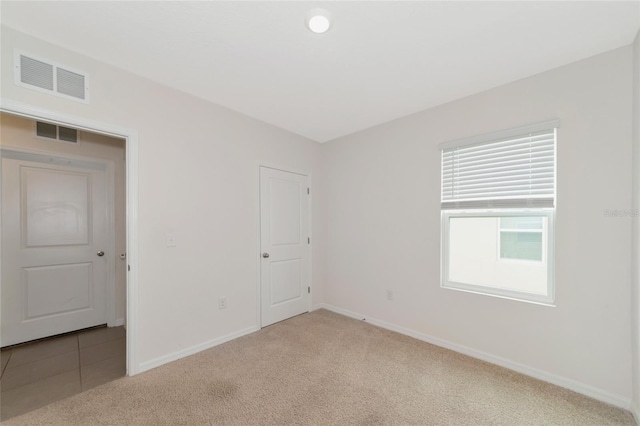 empty room with light colored carpet